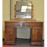 An early 20th century oak dressing table, with mirror, two long drawers over two deep each side,