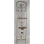 An ornate metal candle holder for wall mounting,