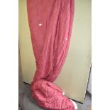 A group of vintage curtains, red with floral decoration,