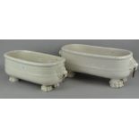 A pair of ceramic planters of oval form, twin handled, raised upon four lion paw feet,