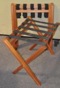 A group of three folding luggage racks,