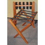 A group of three folding luggage racks,