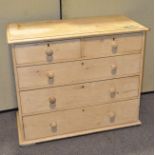 A Victorian pine chest of drawers, with two short and three long drawers,