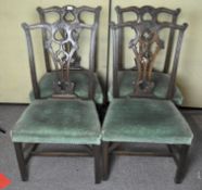 A set of four late 19th century mahogany dining chairs with upholstered seats,