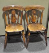 A pair of ash and elm kitchen chairs, with vase shaped splats and solid seats,