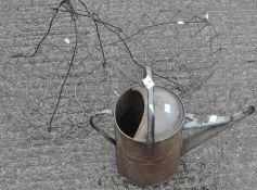 A galvanised metal watering can;