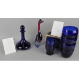An assortment of blue coloured glass, including cups,