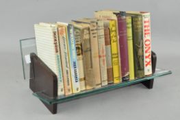A small bookshelf together with a collection of books including James Bond,