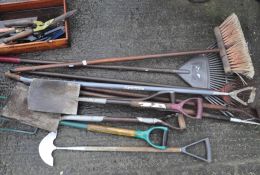 A quantity of garden tools, including spades,