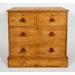A Victorian pine chest of two short and two long drawers with turned pulls and plinth base,