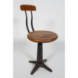 A Singer machinists stool, the revolving beech seat on a cast iron adjustable base,