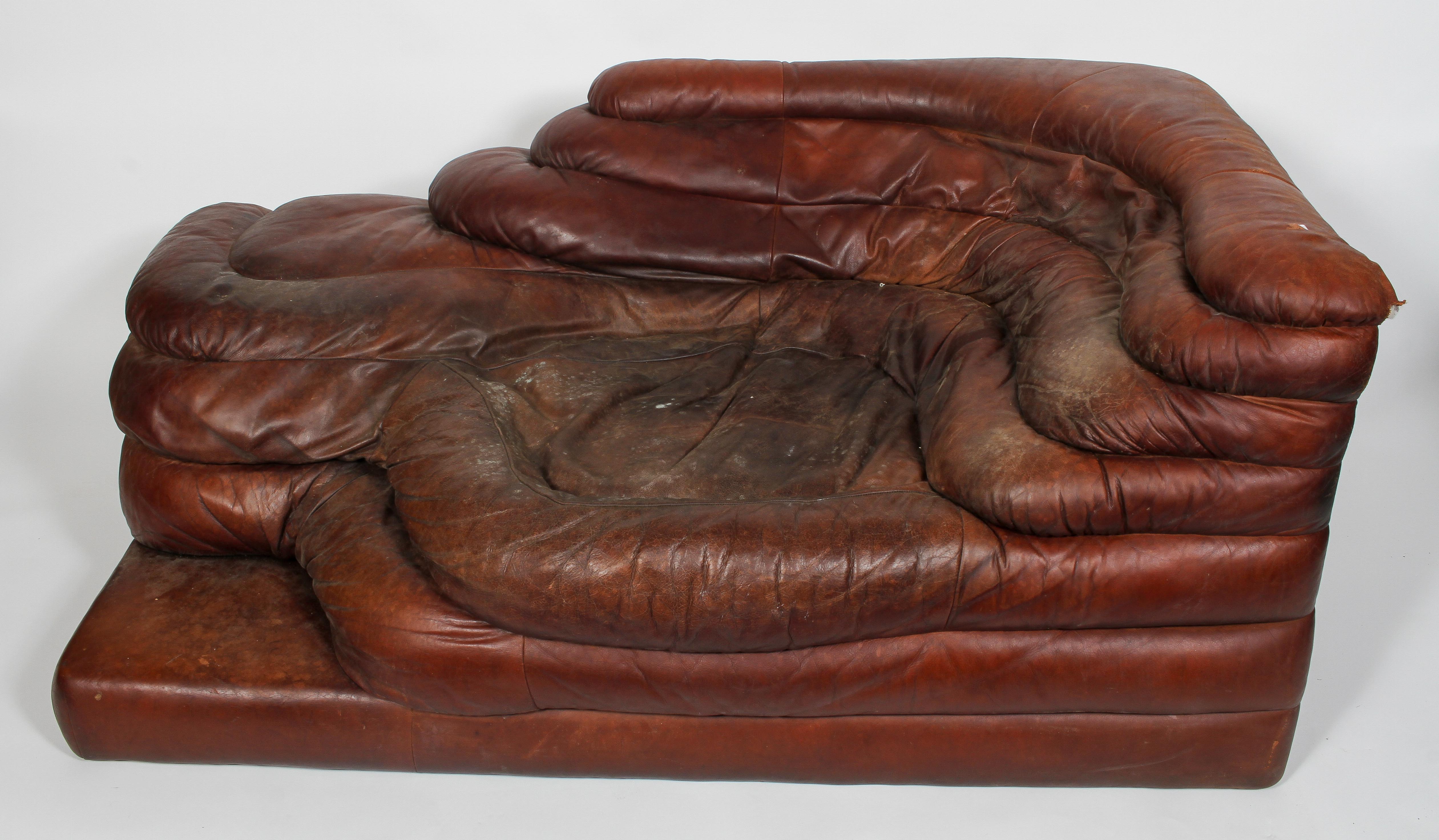 A 20th century vintage leather chaise longue, of rippled form, possibly of Danish design,