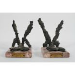 A pair of Coventry Blitz bookends, formed from shrapnel on pink marble bases,