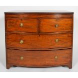 A Regency mahogany bow fronted chest of two short and two long drawers with brass ring pulls,