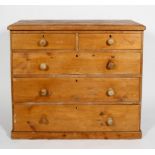 A Victorian pine chest of two short over three long drawers, with turned pulls, on a plinth base,