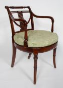 A Regency style mahogany elbow chair, the lyre back and scrolled arms above an oval caned seat,