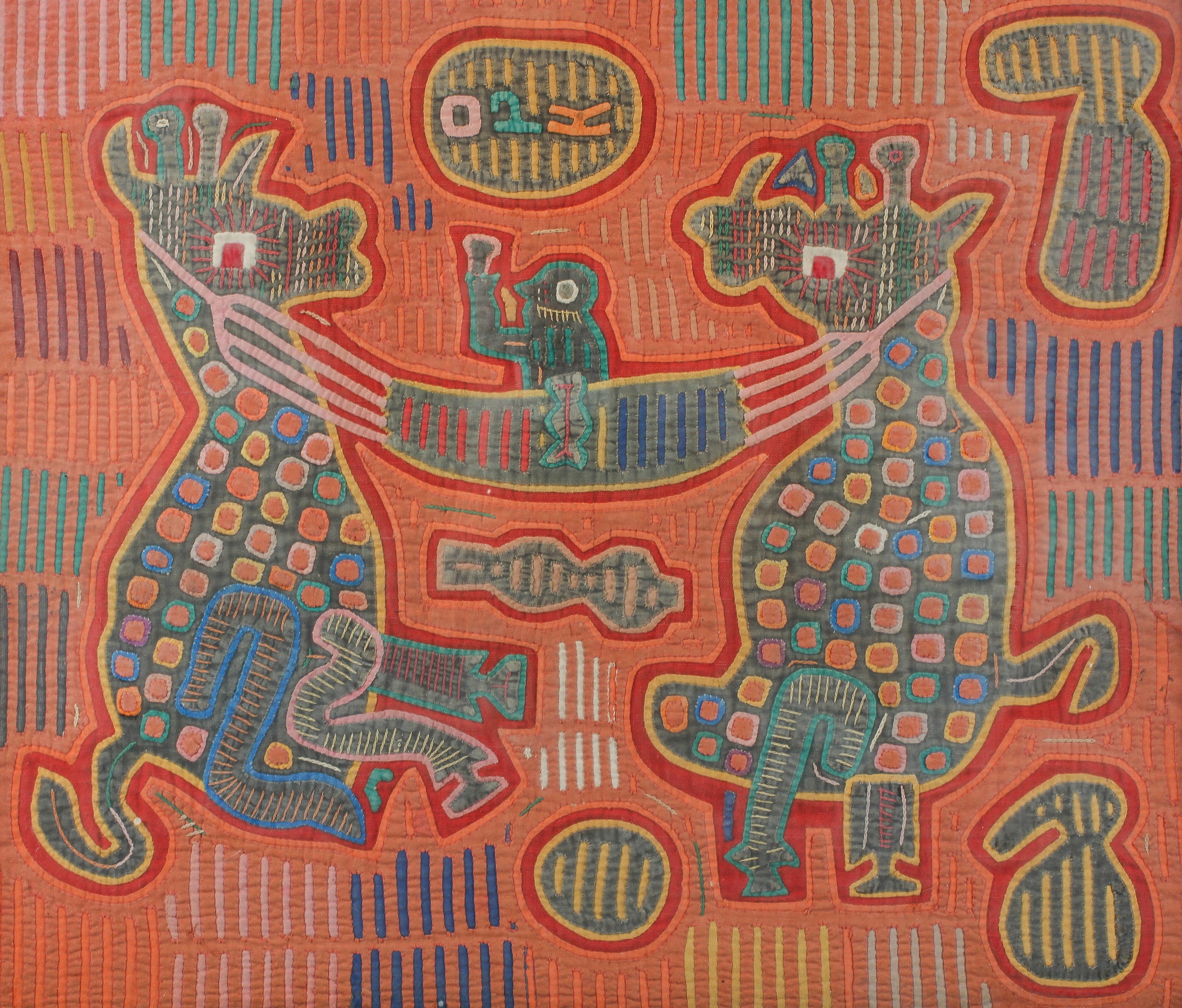 A San Blas Mola of two beasts holding a human figure,