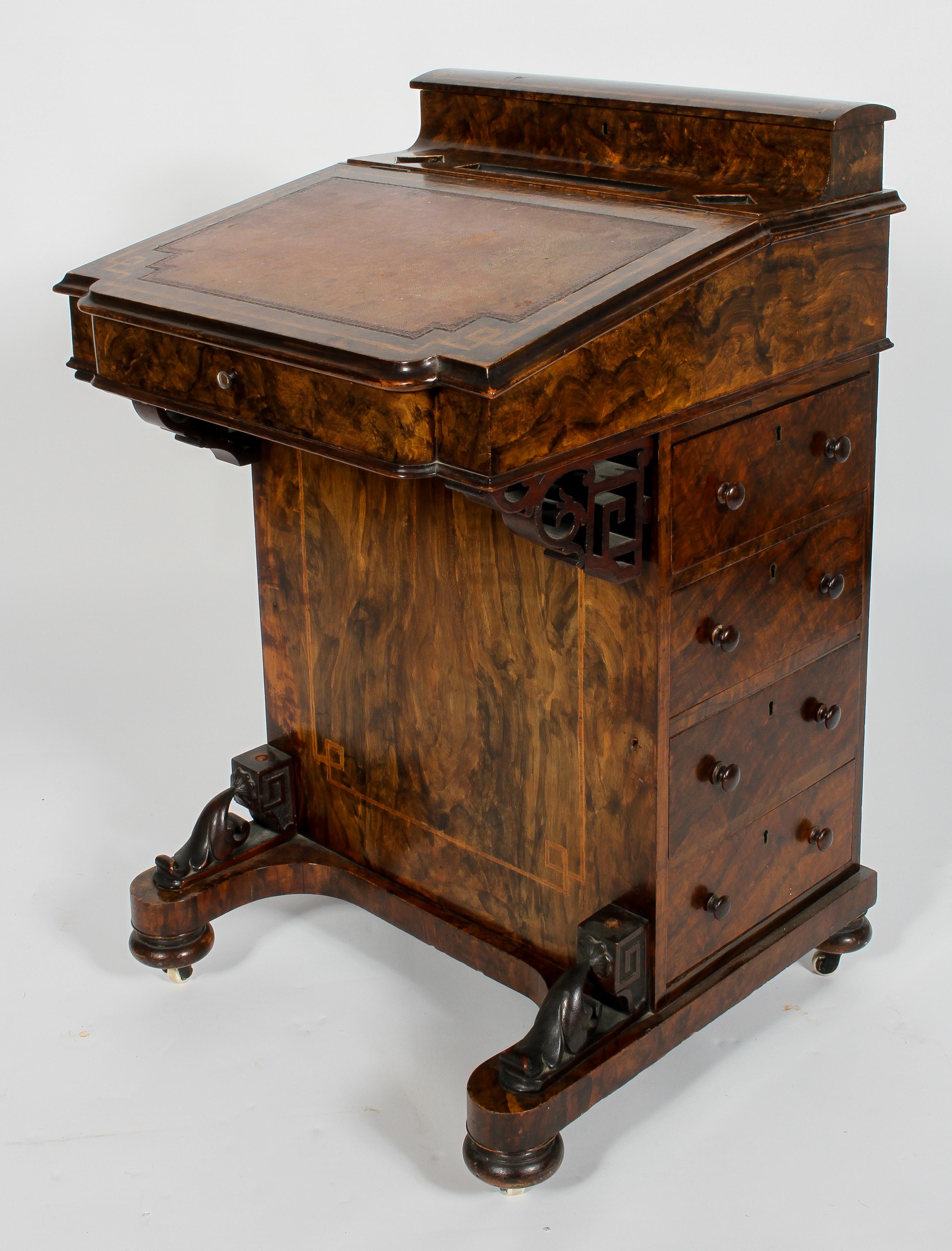 A Victorian walnut effect davenport, with stationery box, birch line interior,