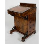 A Victorian walnut effect davenport, with stationery box, birch line interior,