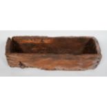 A rustic elm trough, well weathered, with an iron ring,
