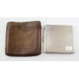 A hallmarked silver cigarette case, the outer with engine turned decoration,