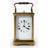 A French gilt brass repeating carriage clock, the enamelled dial on a brass, eight day movement,