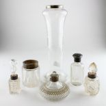 A collection of silver mounted glass cosmetics bottles and jars; and a silver mounted glass vase,