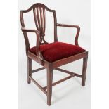 A Hepplewhite style mahogany elbow chair, with pierced splat and drop in seat,