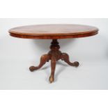 A Victorian mahogany oval tilt top loo table, on a quadripartite base,