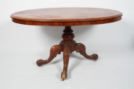 A Victorian mahogany oval tilt top loo table, on a quadripartite base,