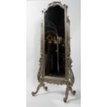 A silvered cheval mirror, the arched plate beneath a scrolling crest and on scrolling supports,