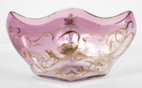 An Art Nouveau style amethyst glass dish, of lozenge form, with trailing floral decoration in gilt,
