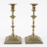 A pair of Victorian brass candle sticks,