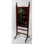 A Regency style mahogany and ebony inlaid rise and fall dressing mirror,