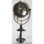 A brass spotlight, possible from a ship, with a 25cm mirrored lamp, black painted handle and spout,