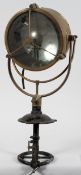 A brass spotlight, possible from a ship, with a 25cm mirrored lamp, black painted handle and spout,