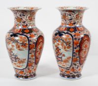 A pair of Chinese 'Imari' pattern baluster vases, 19th century, each with everted neck,