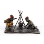 A Bergmann style bronze group of two Arab boys by a fire,