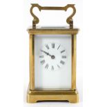 A brass carriage clock, the enamel dial with Roman Numerals denoting hours,