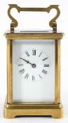 A brass carriage clock, the enamel dial with Roman Numerals denoting hours,