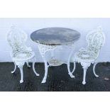 A pair of Victorian cast iron patio chairs and a conforming table with a later marble top,