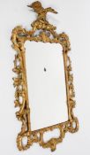 A Chippendale style gilt wall mirror, the rectangular plate in a scrolling pierced frame,