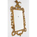 A Chippendale style gilt wall mirror, the rectangular plate in a scrolling pierced frame,