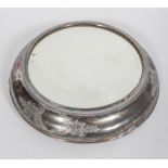 A silver plated mirrored stand, of circular form,