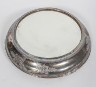 A silver plated mirrored stand, of circular form,