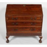 A George III mahogany bureau with a fitted interior above three graduated drawers and claw on ball