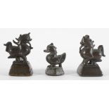 A group of three bronze opium weights, probably Chinese, in the form of a duck and two dragons,