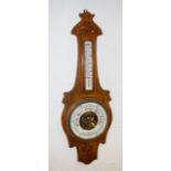 An aneroid barometer, by George Perry & Co, Bournemouth, on an Arts and Crafts style walnut mount,