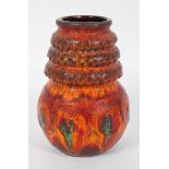 A 1960's West German pottery vase, with bulbous base and ribbed tapering neck, in a fat lava glaze,