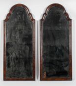 A pair of Queen Anne style walnut framed mirrors, of arched form, the glass with a star motif,